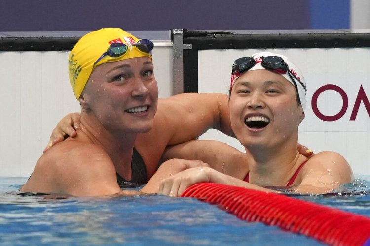 Olympics Latest: Canada's MacNeil takes butterfly gold